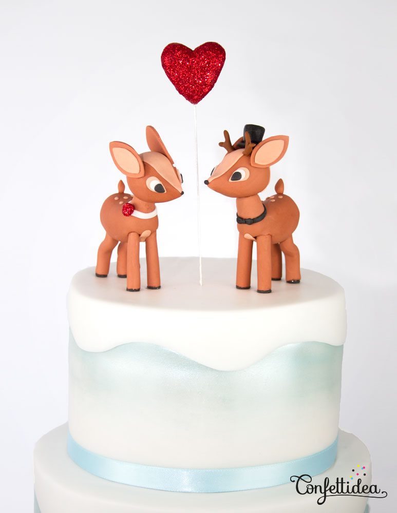 winter wedding cake with reindeer figurines
